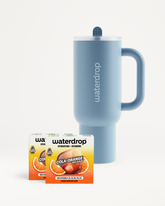 COLA ORANGE Explorer Set obsahuje Twin Pack COLA ORANGE a břidlicově modrý Termo Hrnek Explorer.